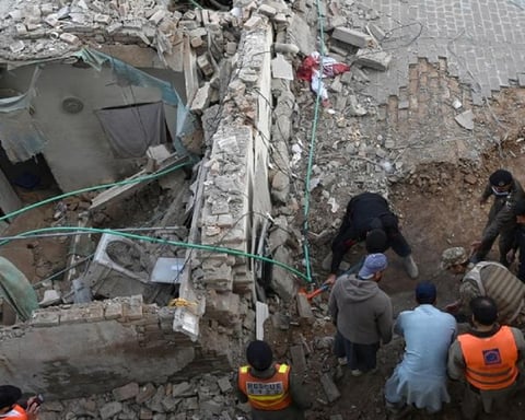 Security personnel and residents rescue injured blast victims from derailed train carriages after a suicide car bomb attack in Quetta, Balochistan