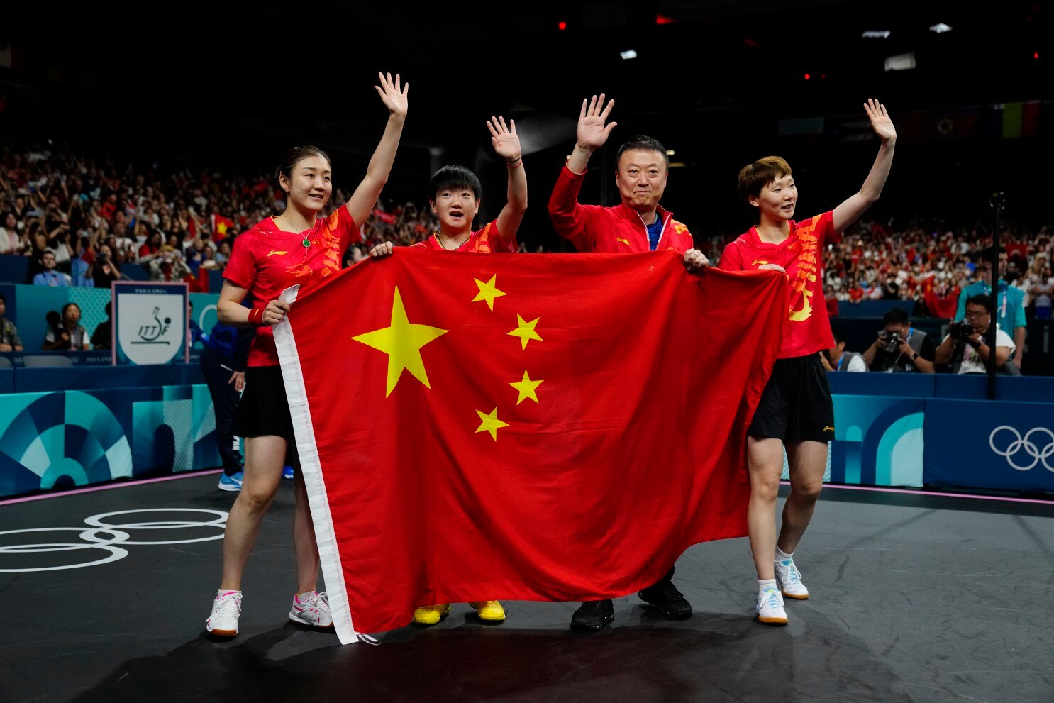 china 2024 olympics table tennis team celebrating gold medal victory in paris