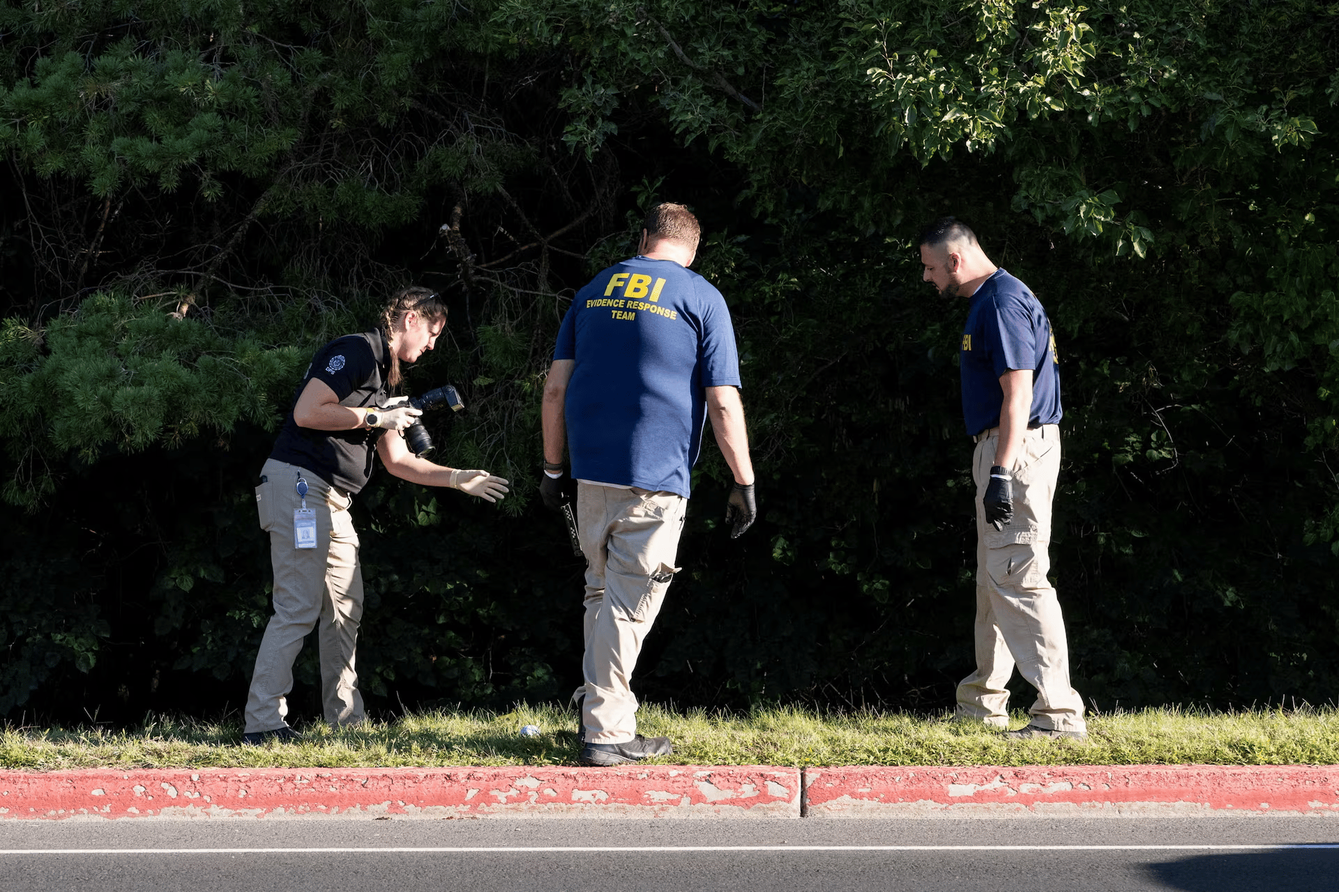 FBI and campus police examine a UVU rooftop with cameras and evidence markers after the fatal shooting of Charlie Kirk in Orem, Utah.