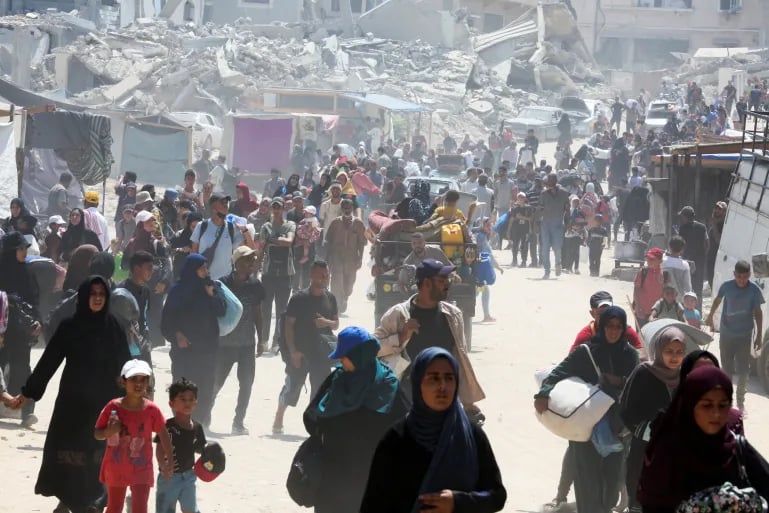 Gaza City buildings burn after Israeli airstrikes amid evacuation and US-backed escalation.