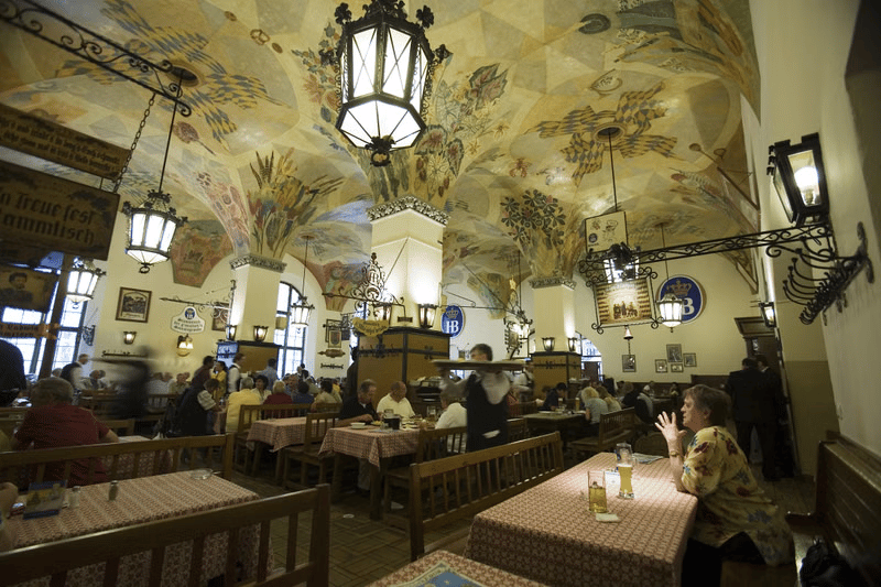 Hofbräuhaus Munich interior with painted ceilings and long tables