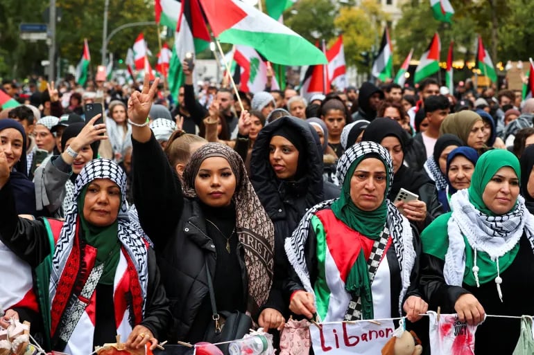 Protesters near UN headquarters in New York holding placards calling for a ceasefire and sanctions.