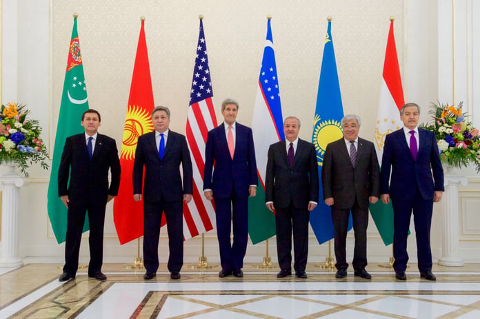 Central Asian leaders stand with flags at a regional summit venue