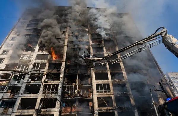 Residents are escorted down ladders from a damaged Kyiv high-rise after a drone strike.