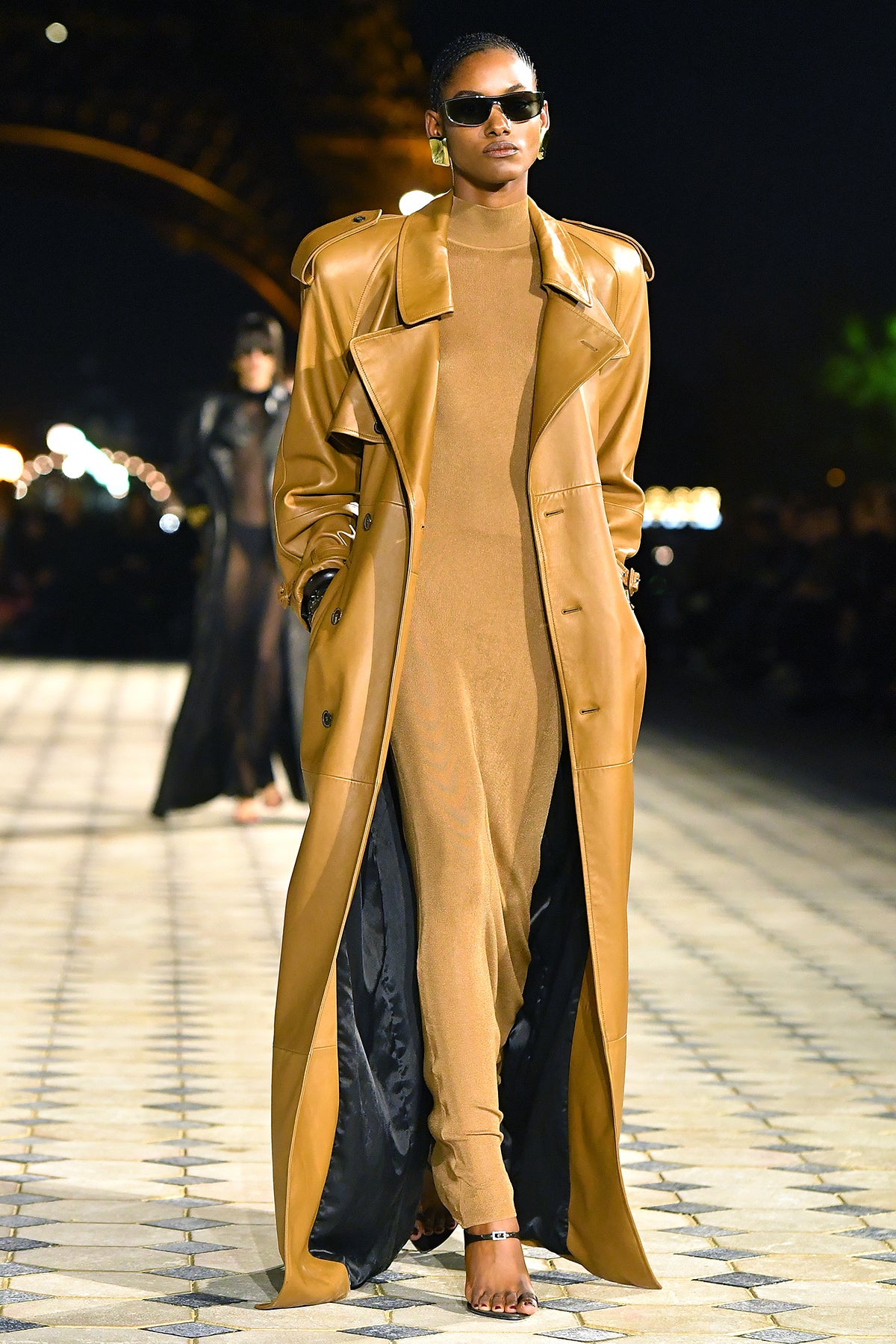 Model in mustard coatdress with high belt and black slingbacks at Saint Laurent Spring 2026