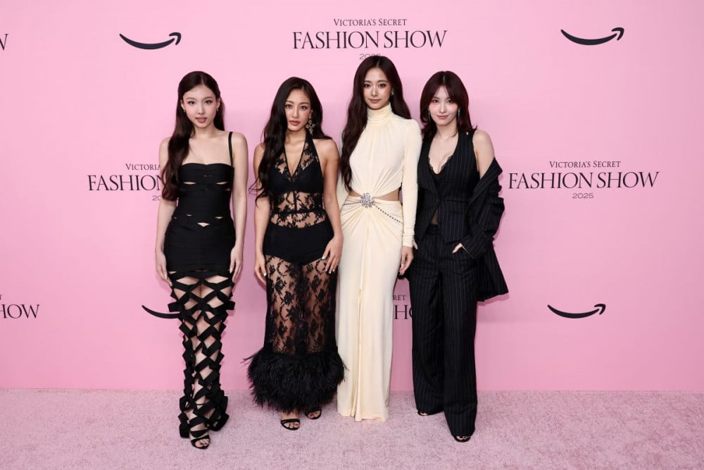 TWICE members on the Victoria’s Secret 2025 stage, dressed in black and cream looks