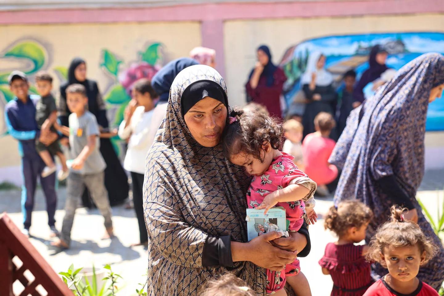 A mother and child wait during a nutrition screening at a UNICEF-supported clinic in the Gaza Strip.