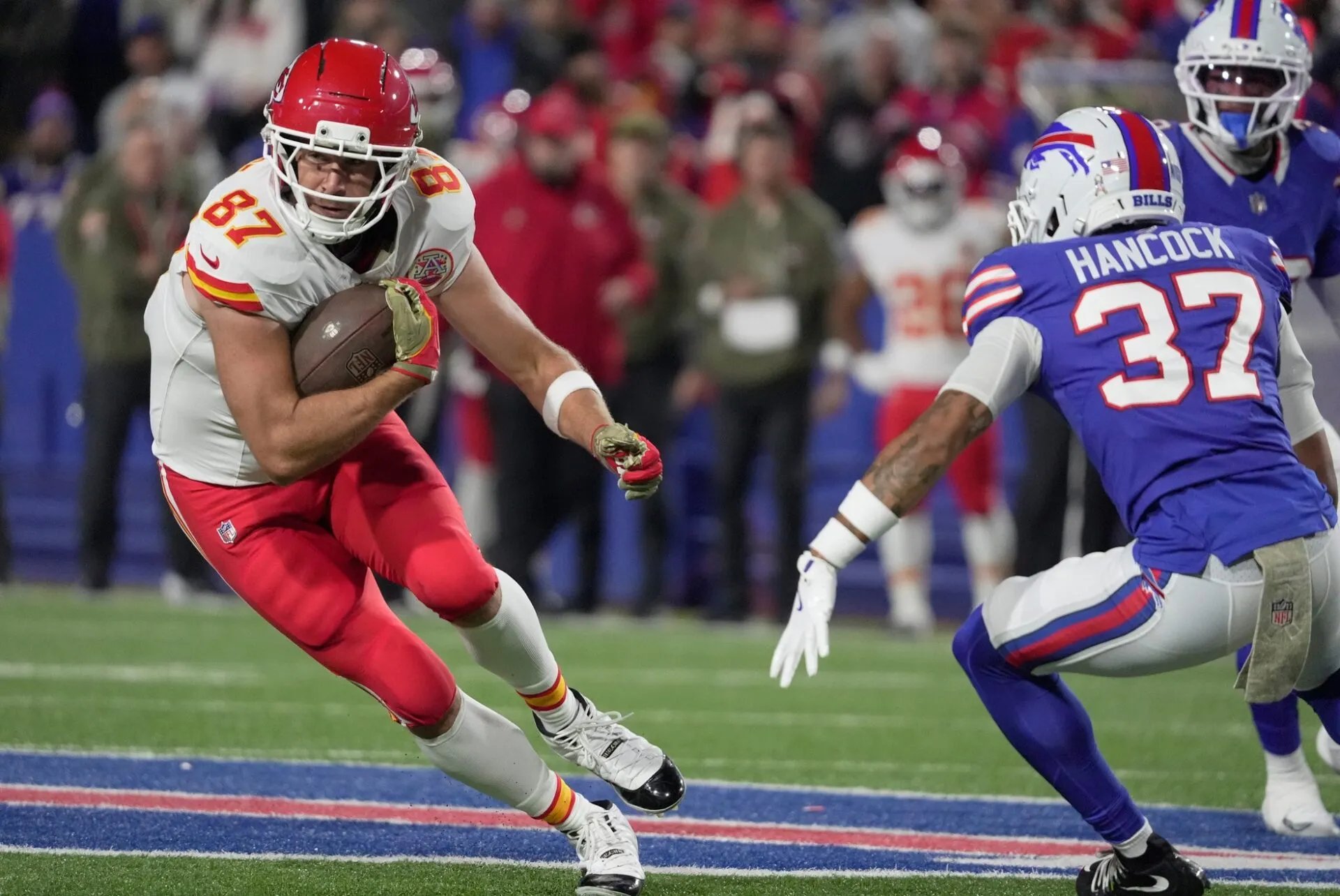 Buffalo Bills player running with football against Kansas City Chiefs defender at Highmark Stadium November 2025