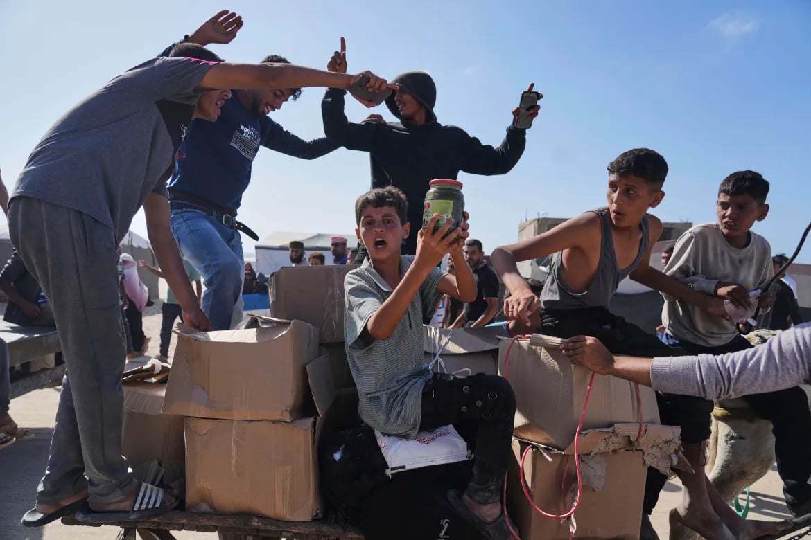 Aid workers delivering essential supplies in Gaza during humanitarian crisis