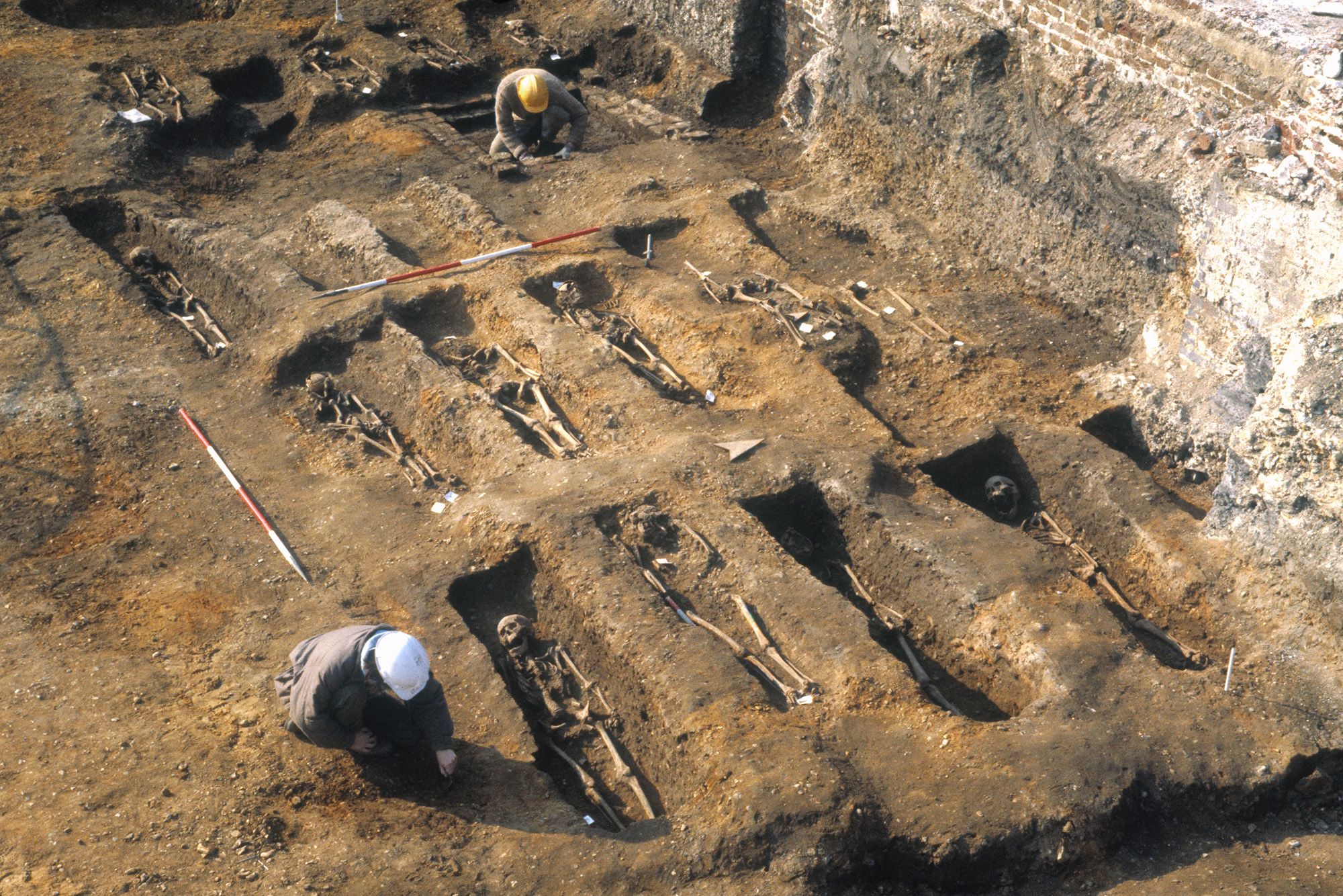 A mass grave in Sudan with UN peacekeepers surveying the site