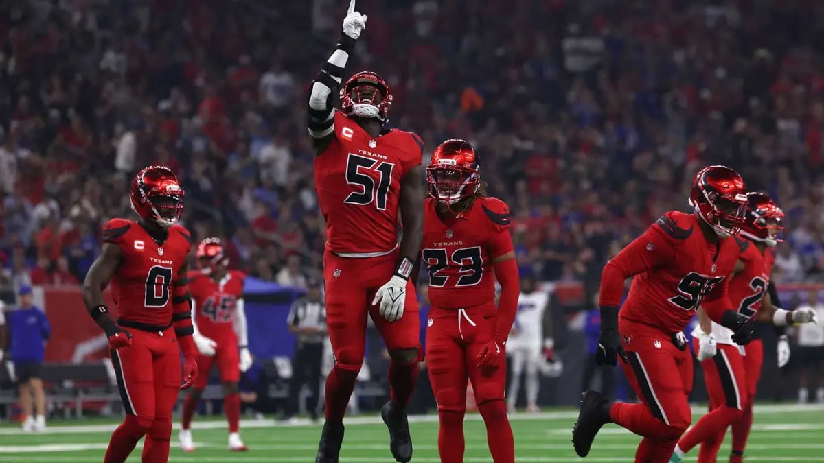 Texans defensive players celebrate after sacking Josh Allen