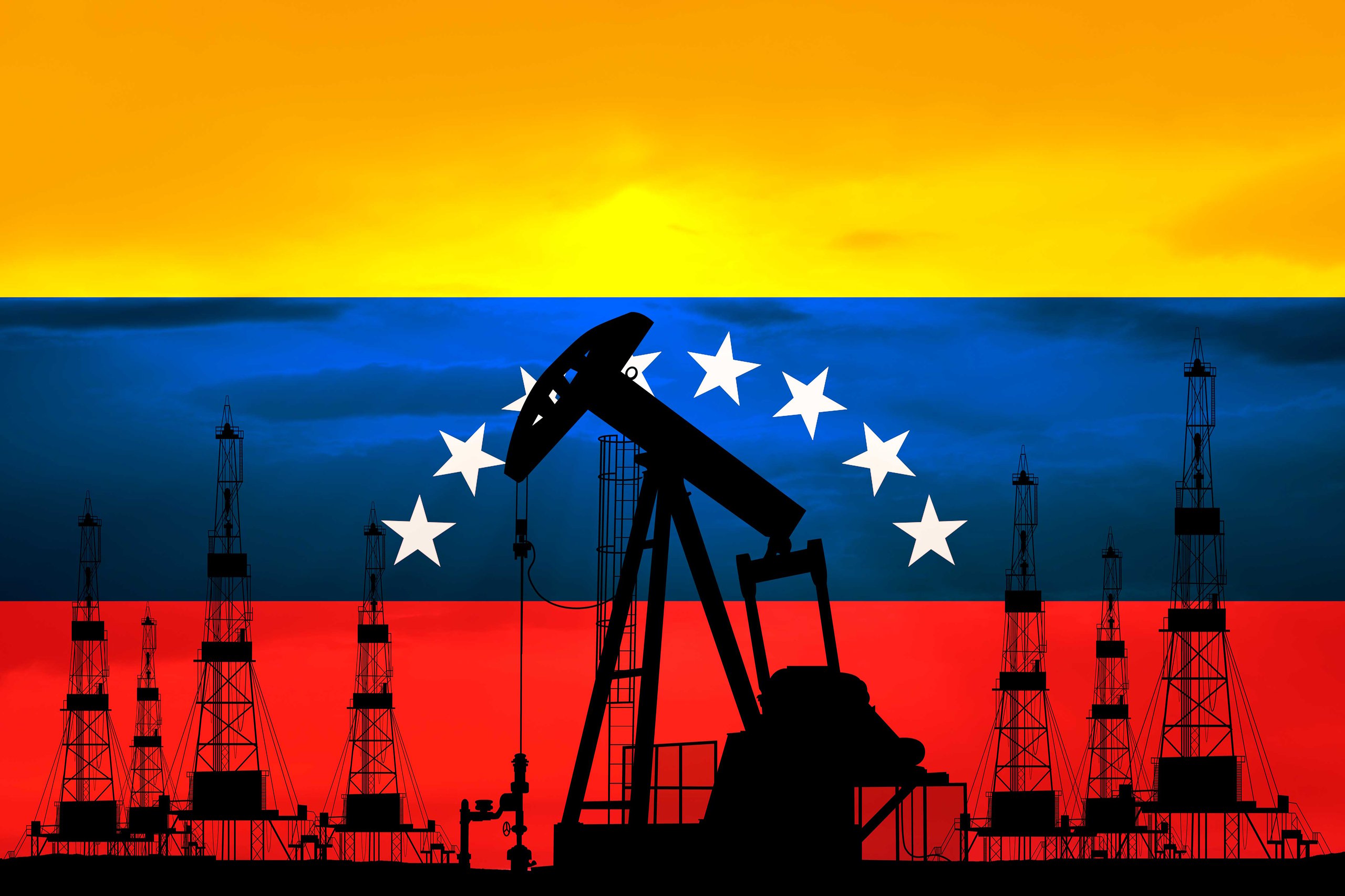 Venezuelan oil fields with pumpjacks and storage tanks at sunset