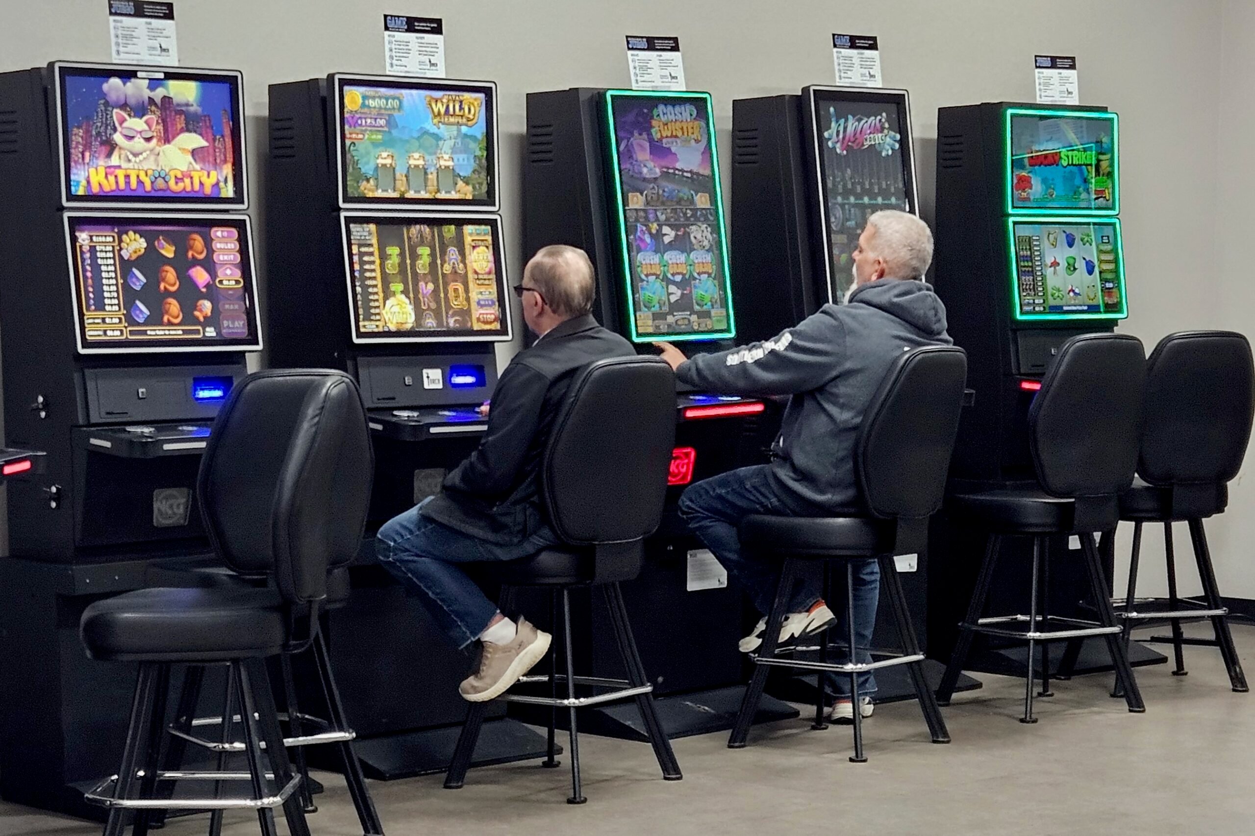 Players using slot machines inside a US casino environment