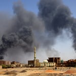 Thick black smoke billowing over residential buildings in El-Obeid, Sudan,