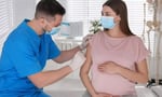 Pregnant woman receiving RSV vaccine consultation showing infant protection through maternal antibodies