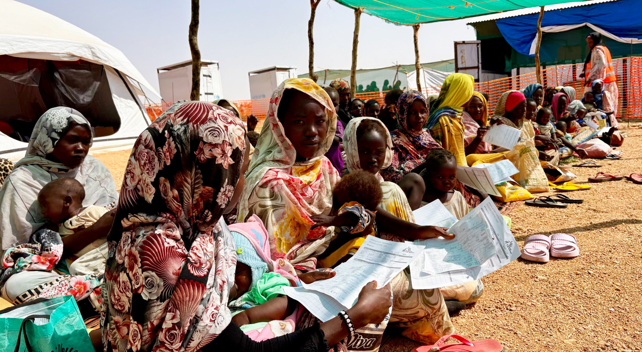 Sudanese women waiting in line for humanitarian aid during the war