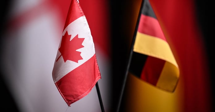 Canadian and German flags at a press conference marking the Ksi Lisims LNG deal with SEFE in 2026
