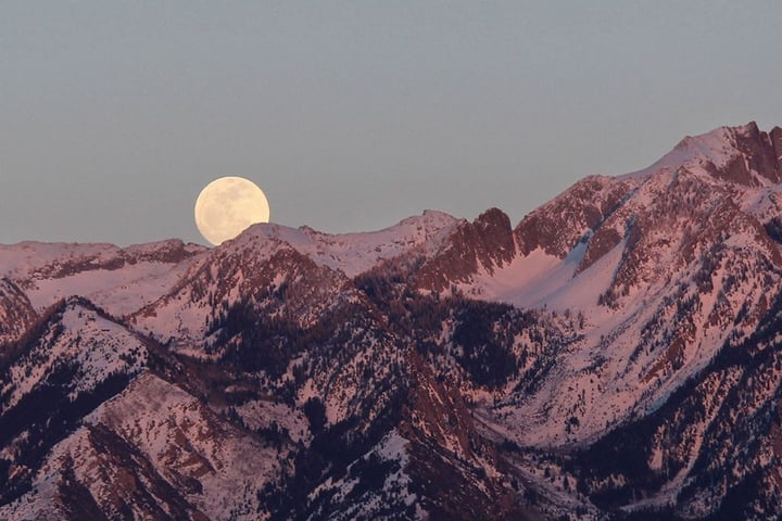 Flower Moon rising on May 1, 2026 over spring landscape with Scorpio constellation in night sky