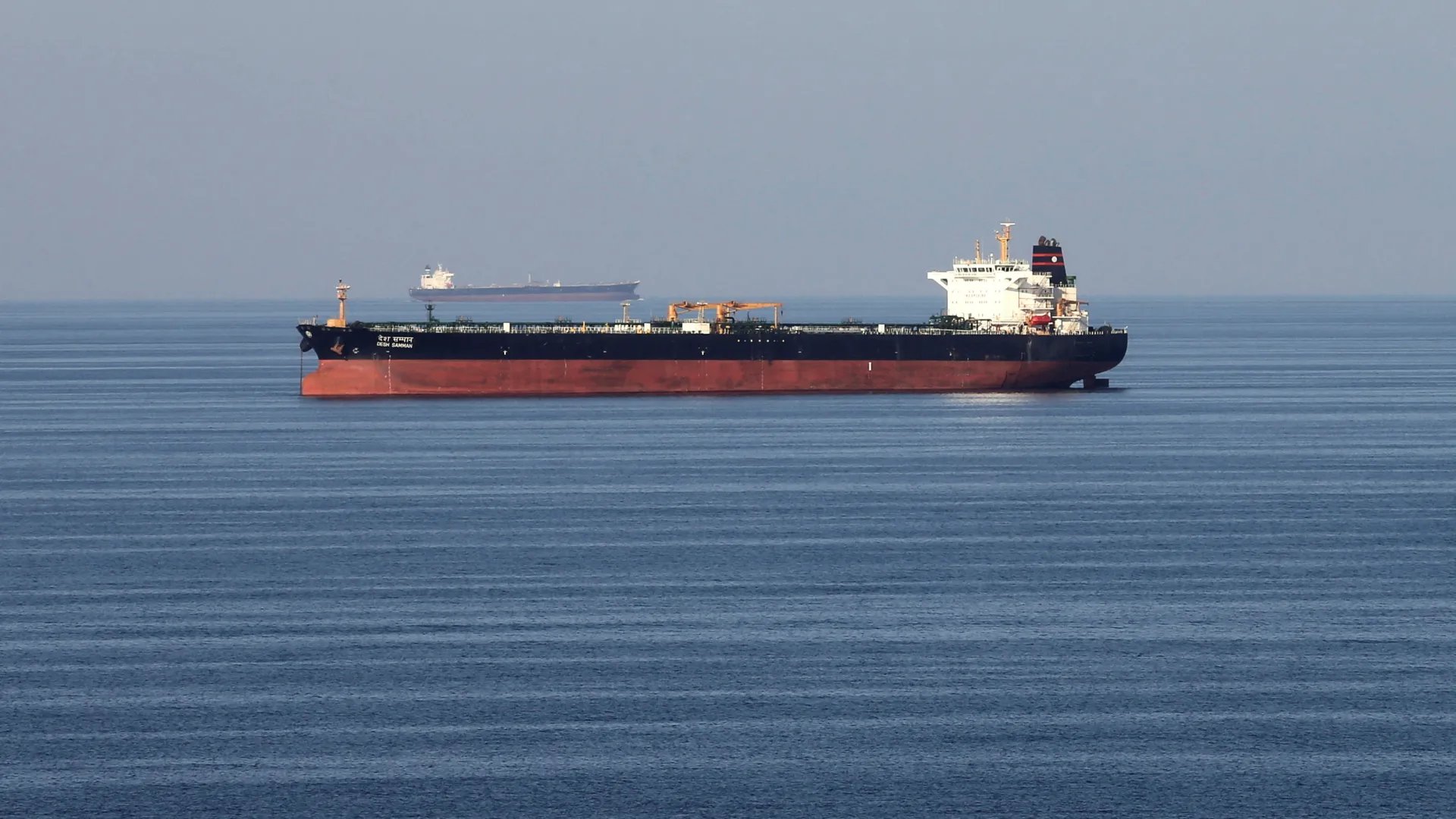 Oil tankers and military vessels near the Strait of Hormuz during escalating Israel-Iran conflict