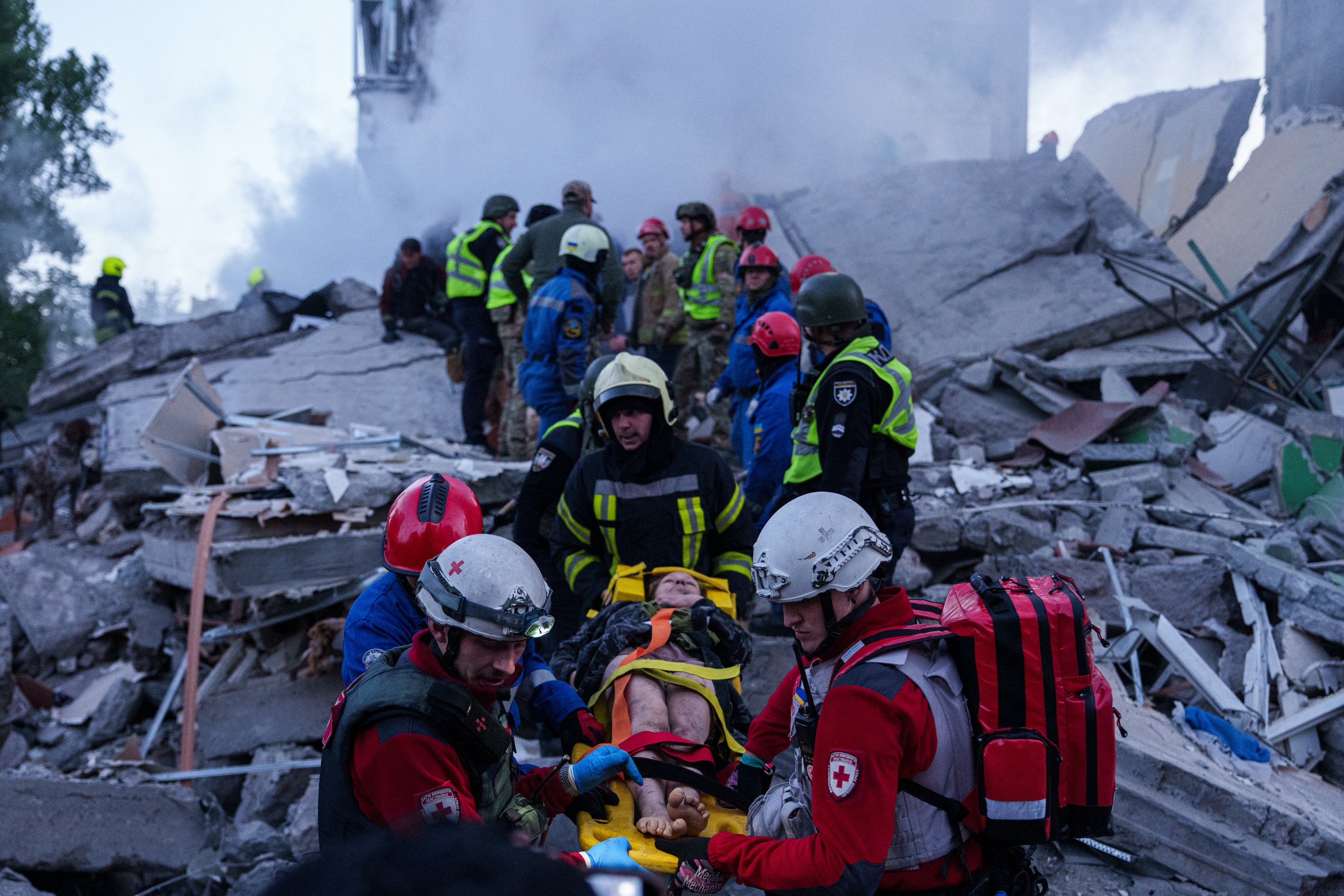 Rescue workers carry an injured woman on a stretcher from a house heavily damaged after a Russian strike on a residential neighborhood in Kyiv, Ukraine, May 2026