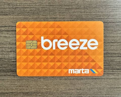 Commuter using Apple Wallet on iPhone to access a MARTA station in Atlanta