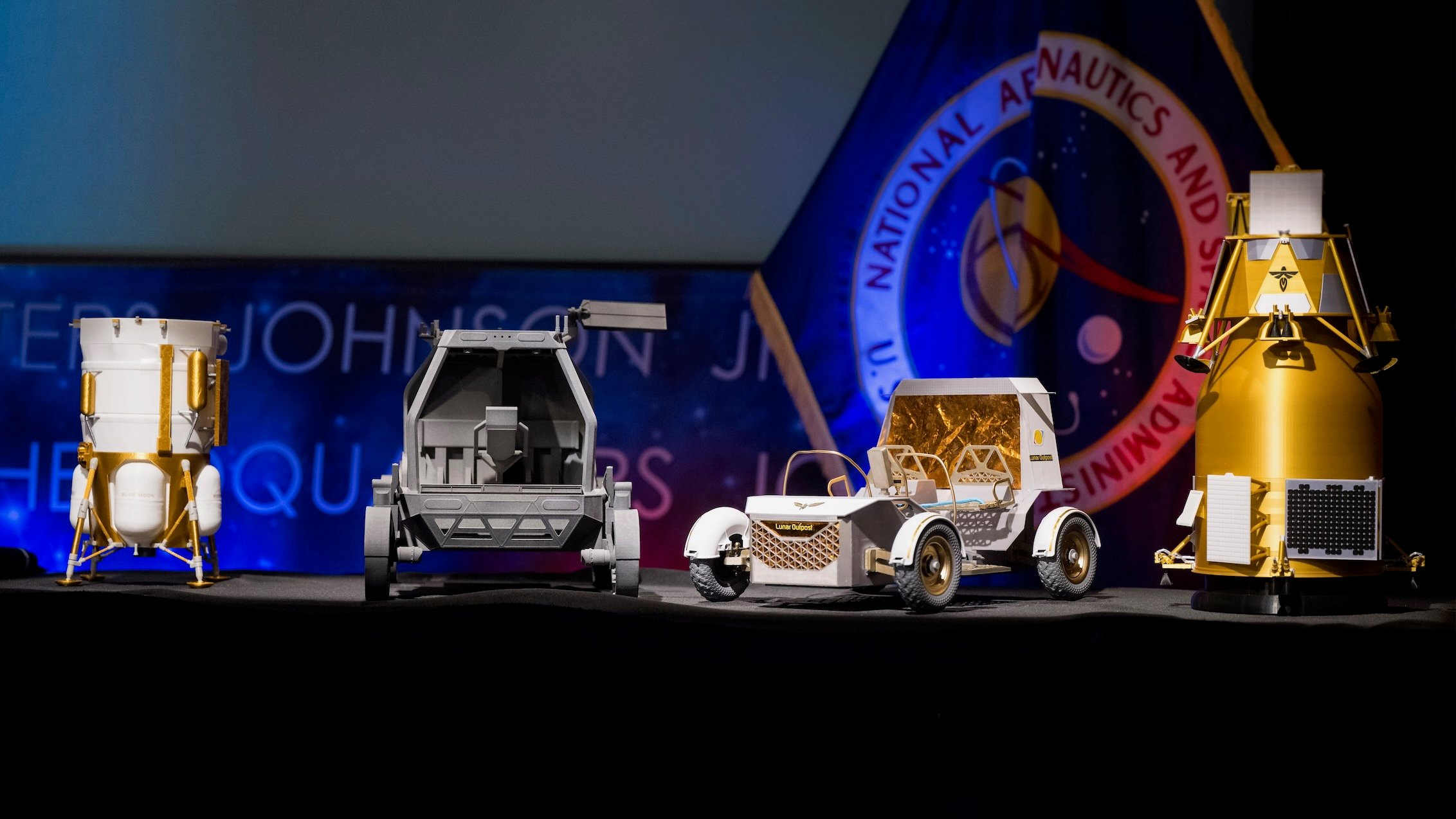 Models of the Blue Origin Blue Moon Mark 1 lander, Astrolab Crewed Lunar Rover, Lunar Outpost Pegasus rover and Firefly Elytra Dark orbiter unveiled at NASA headquarters on May 26, 2026