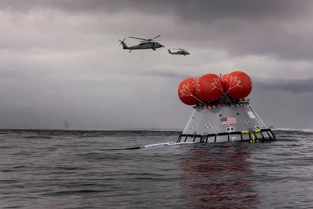 NASA recovery teams retrieving Orion capsule in Pacific Ocean after splashdown