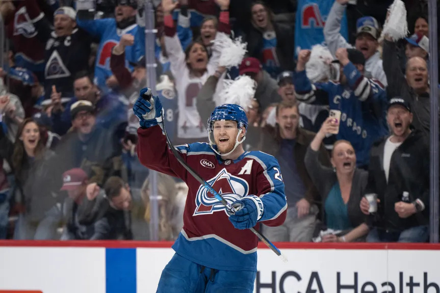 Nathan MacKinnon pressured by Minnesota Wild defense during NHL playoff game
