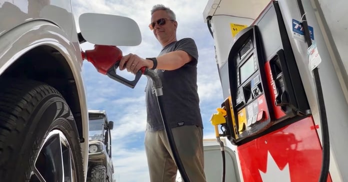Drivers fill vehicles at a gas station in Newfoundland after fuel prices dropped ahead of the Victoria Day weekend