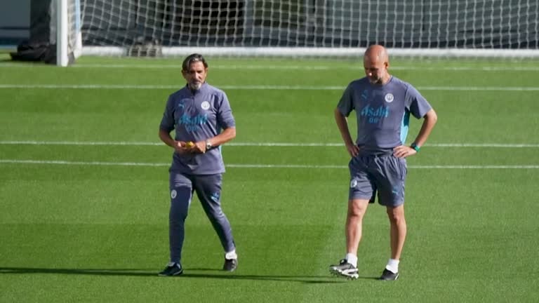 Pep Guardiola gives instructions during Manchester City training