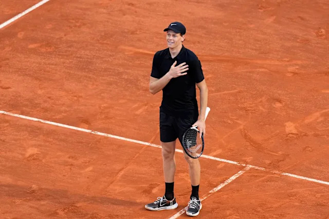 Jannik Sinner serving during Roland Garros 2026 match on clay court