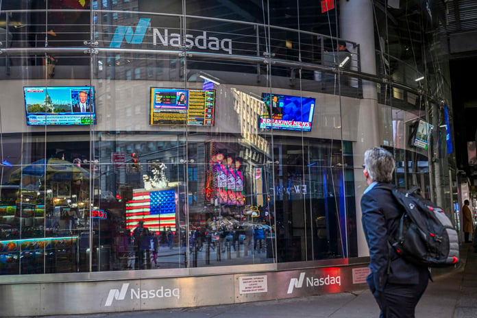 Donald Trump displayed on screens at the New York Stock Exchange during controversy over massive stock trade disclosures