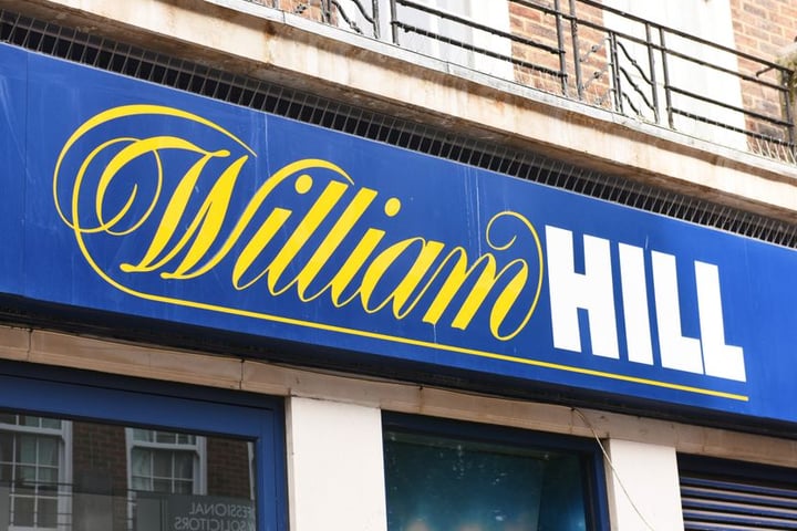 William Hill betting shop exterior Britain Evoke Bally's Intralot takeover 2026