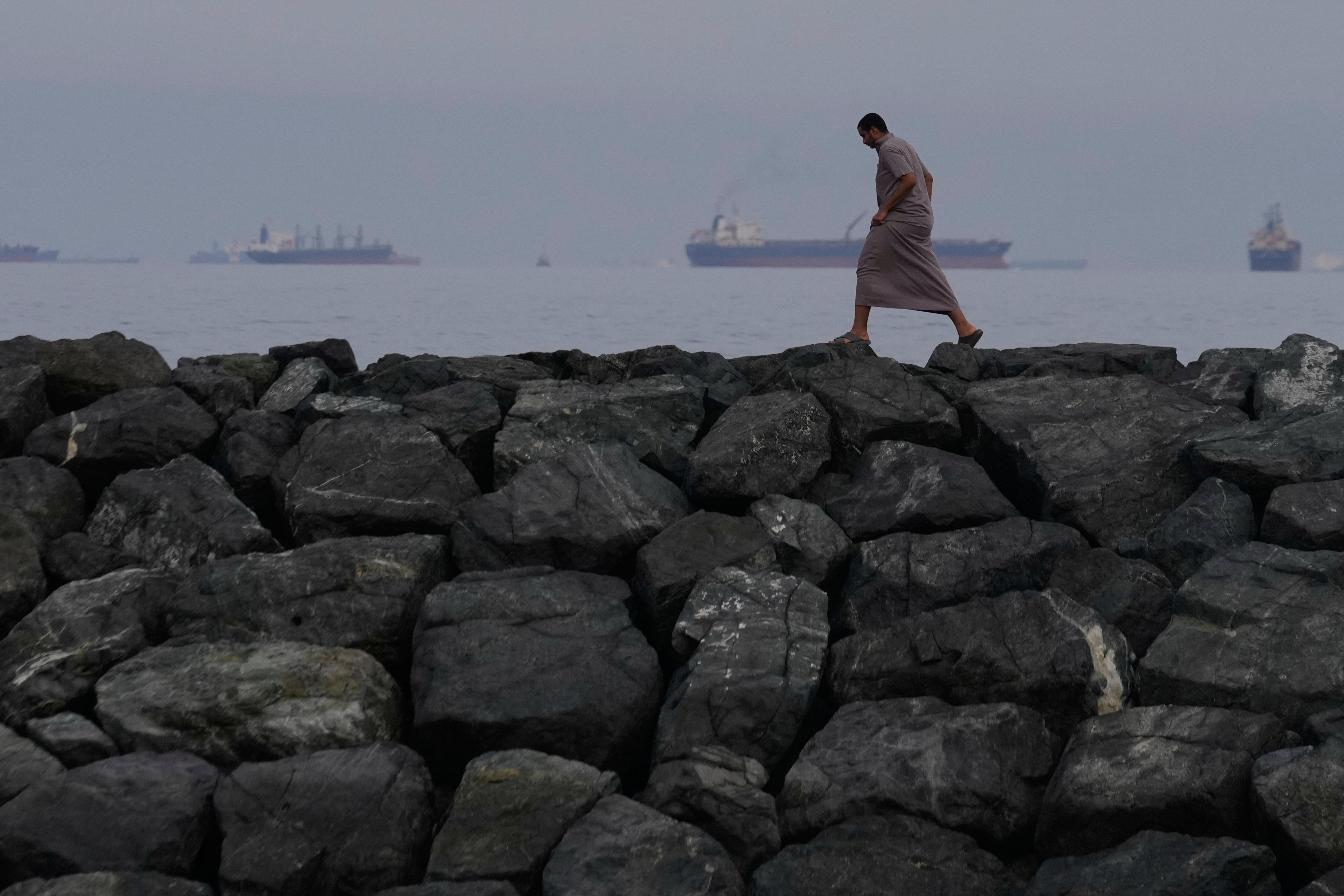 Oil tankers and cargo ships line up in the Strait of Hormuz as seen from Khor Fakkan UAE amid Iran blockade 2026
