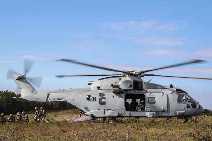 A Royal Navy Merlin Mk4 helicopter in flight, operated by the Fleet Air Arm Commando Helicopter Force