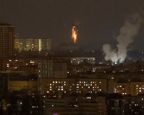 A Ukrainian drone explodes in the night sky over Kyiv during a Russian drone strike