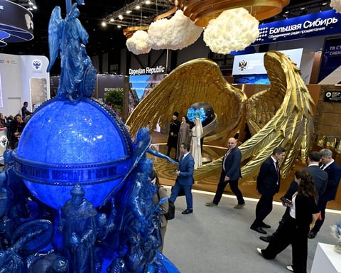 Participants tour the exhibition hall at SPIEF 2026 in St. Petersburg Russia