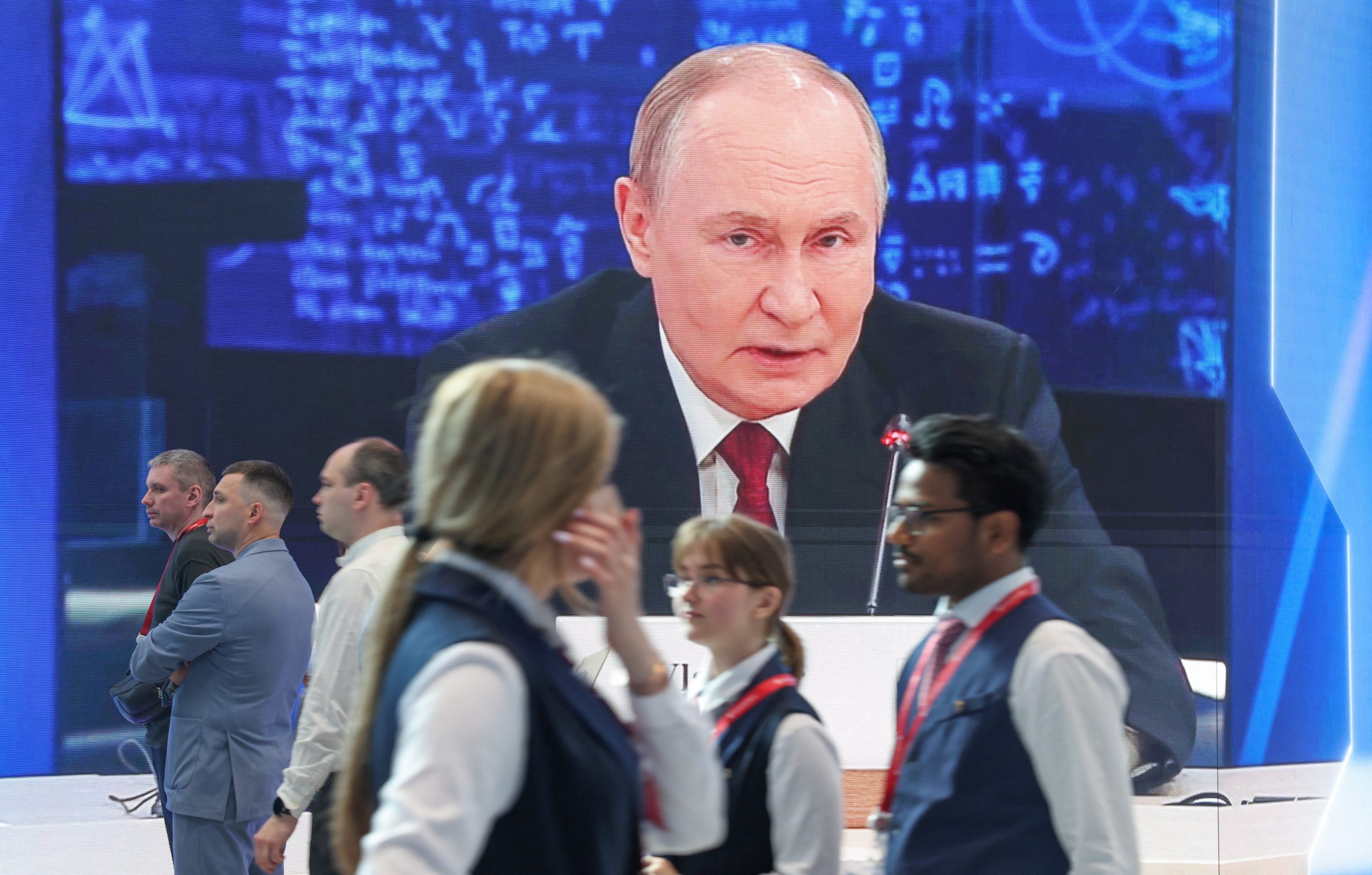 Participants at the 29th St. Petersburg International Economic Forum with Vladimir Putin on screen, June 3 2026