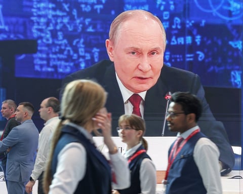 Participants at the 29th St. Petersburg International Economic Forum with Vladimir Putin on screen, June 3 2026