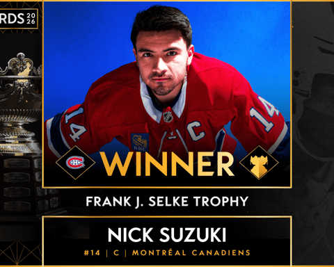 Nick Suzuki and Cole Caufield with the Selke and Lady Byng trophies in the Montreal Canadiens locker room