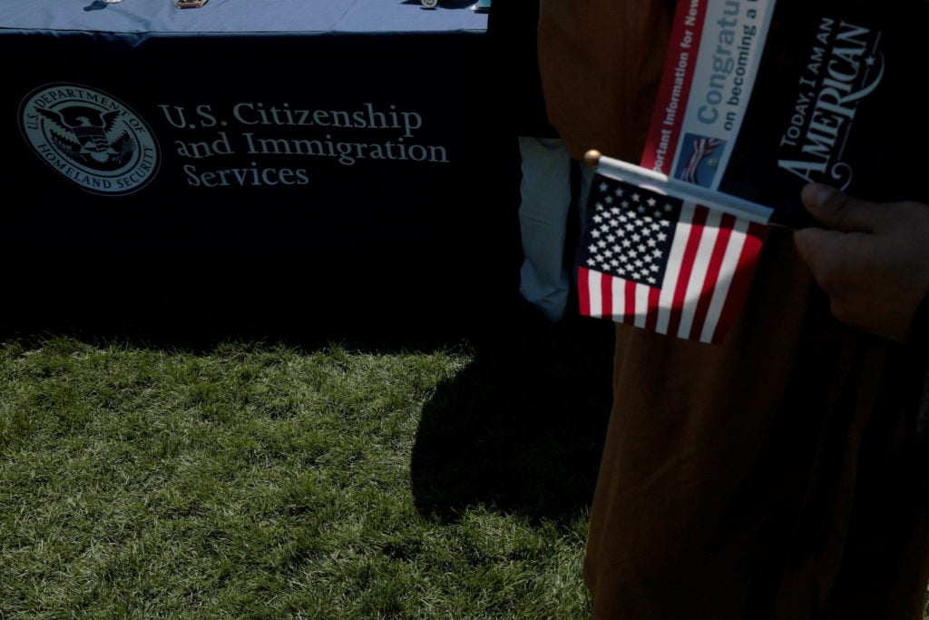 Immigrants at a USCIS naturalization ceremony as Trump administration restricts asylum access