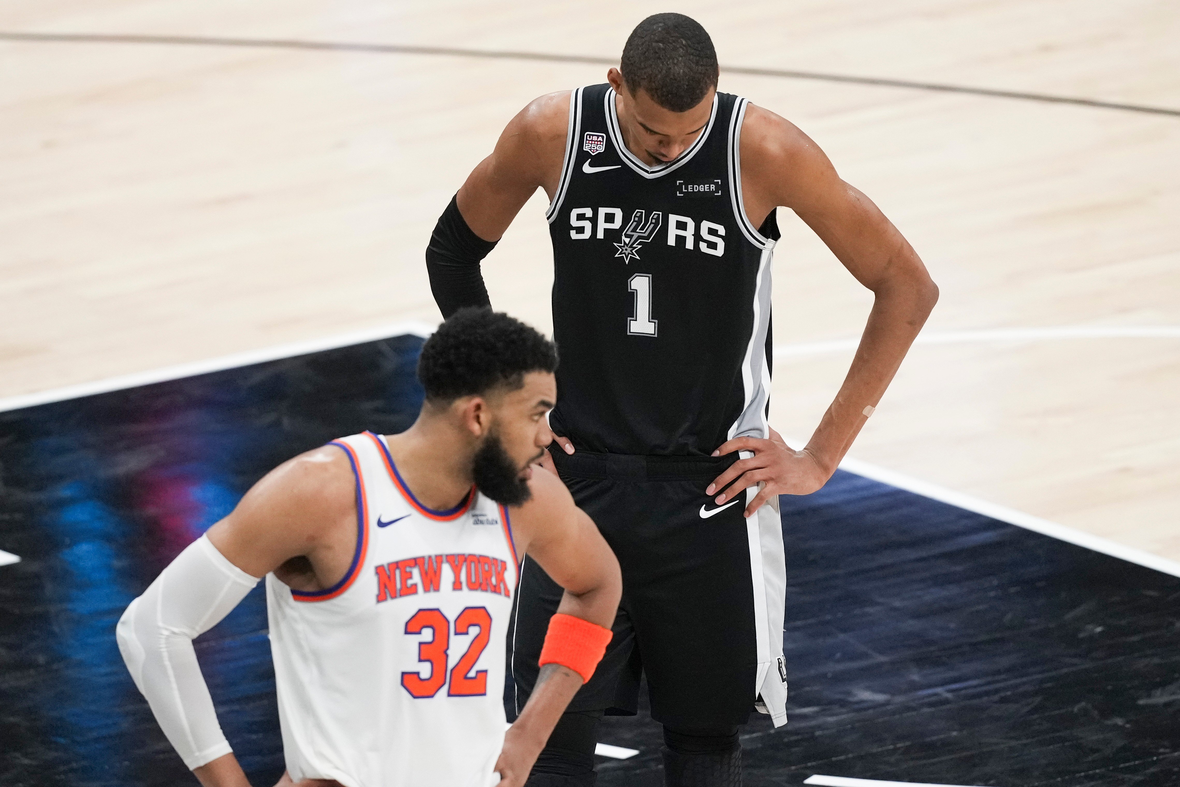 Victor Wembanyama of the San Antonio Spurs and Karl-Anthony Towns of the New York Knicks during Game 1 of the 2026 NBA Finals at Frost Bank Center